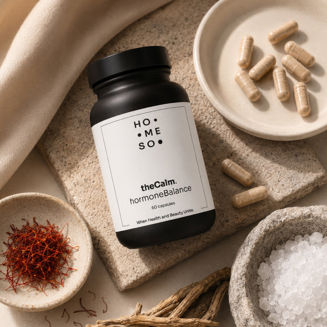 Jar of theCalm. hormoneBalance with capsules, saffron and other natural ingredients on a stone surface