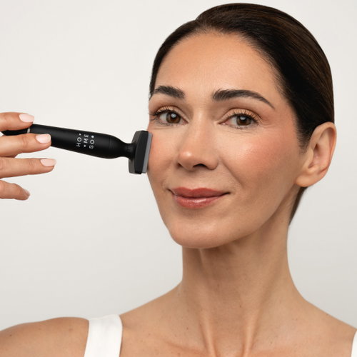 Woman using the HoMEso Micro Stamp on her cheek
